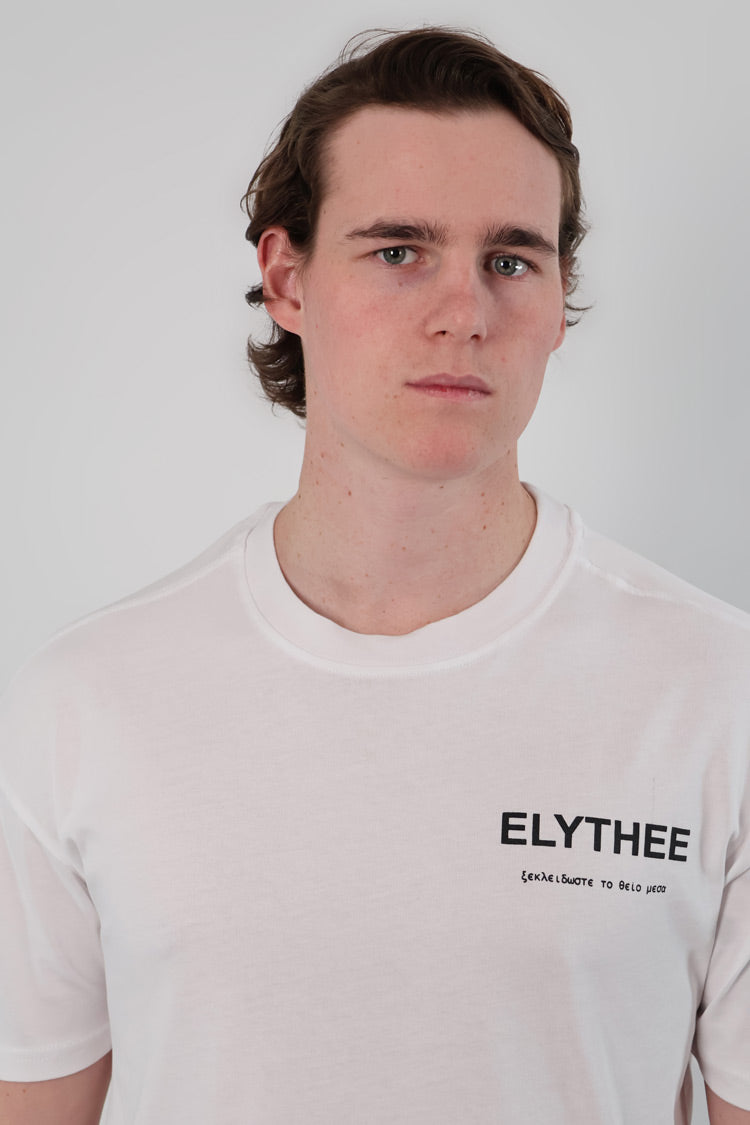 A person with short brown hair is wearing the Legacy T-Shirt - Unisex, a minimalist bold statement piece crafted from premium breathable cotton.