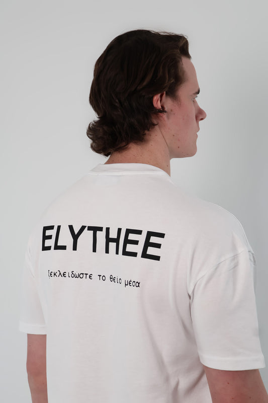 A person with brown hair is wearing the Legacy T-Shirt - Unisex. Made from premium breathable cotton, this minimalist bold statement piece features ELYTHEE and Greek letters printed on the back.