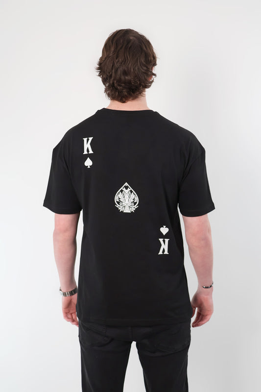 An individual wearing the Olympian Royale Oversized T-Shirt featuring a king of spades card design on the back.