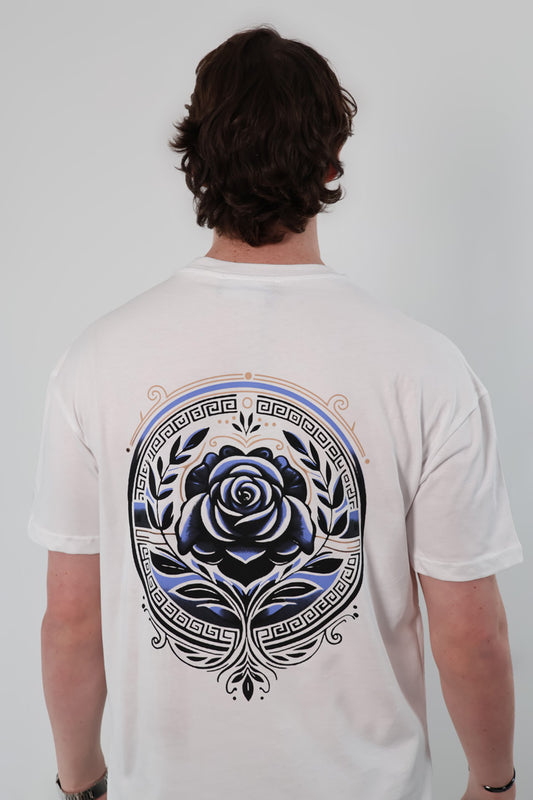 Person wearing the Aegean Rose T-Shirt, featuring a blue rose and intricate circular design on the back.