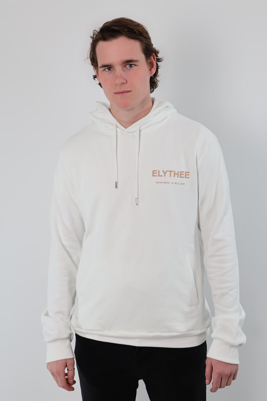 A person wearing an Eternal Laurel Hoodie - Unisex, featuring the text ELYTHEE, paired with black pants, stands against a plain white background.