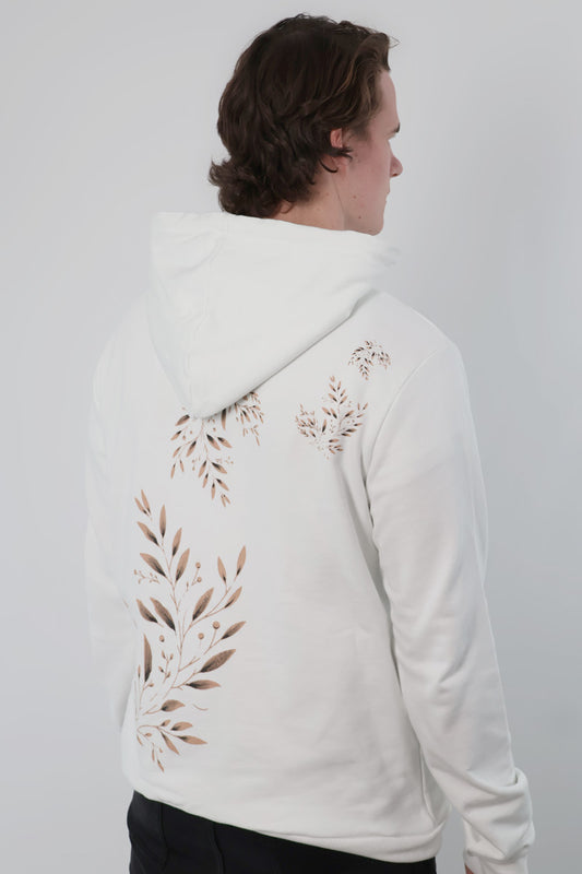 A person wearing the Eternal Laurel Hoodie - Unisex, featuring leaf patterns on the back, stands against a neutral background.