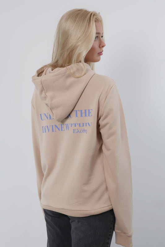 Someone with long blonde hair, slightly turned to the side, is wearing the Mythos Essence Hoodie - Unisex in beige featuring blue text on the back against a plain white backdrop.