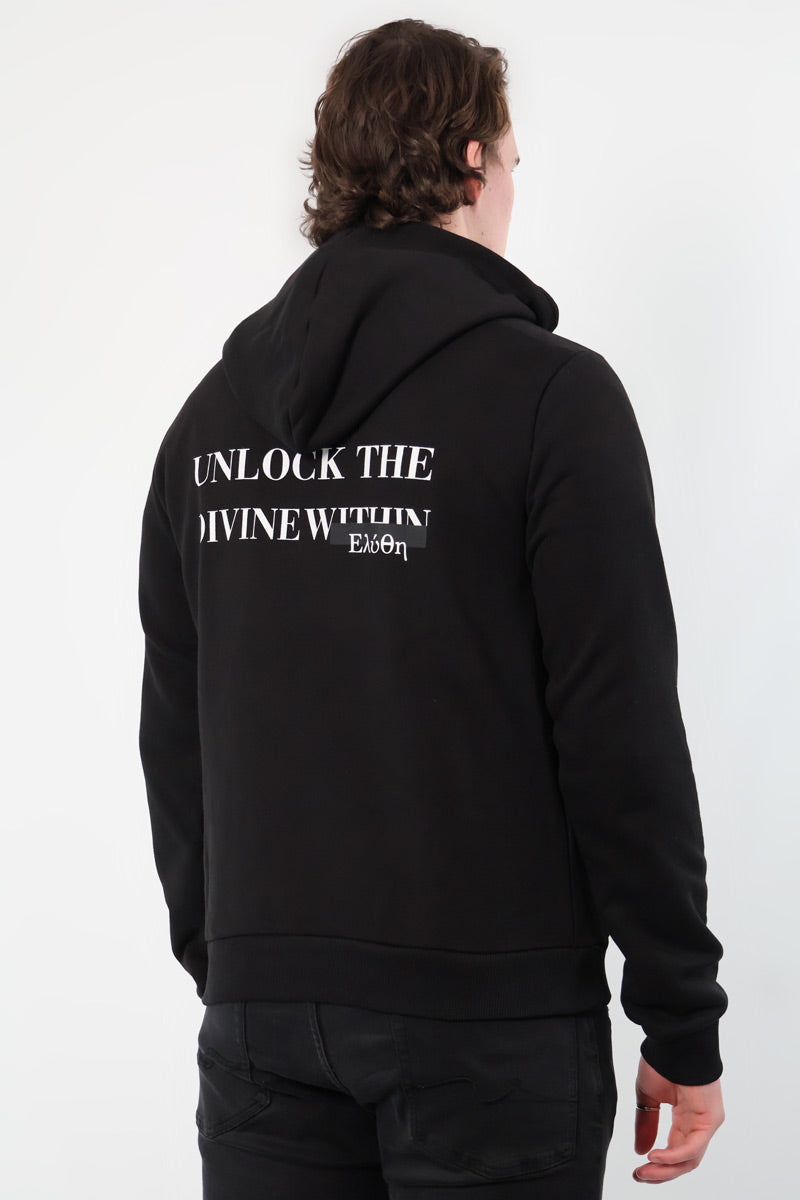 A person in a Mythos Essence Hoodie, featuring Unlock the divine within on the back, stands against a white background.