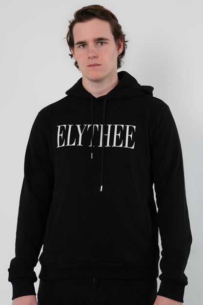 A person wearing a Nectar Nomad Hoodie, the classic unisex staple, stands against a plain backdrop. ELYTHEE is boldly emblazoned across their black hoodie, capturing attention with its minimalist appeal.