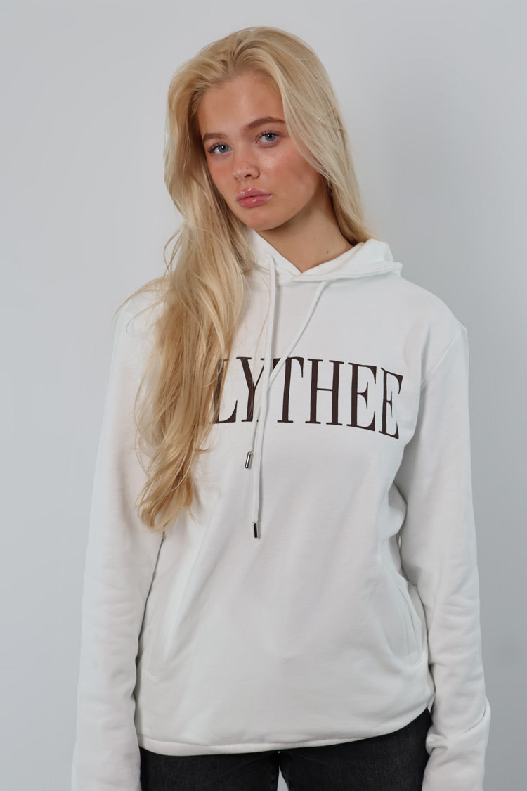 A person with long blonde hair wearing a Nectar Nomad Hoodie stands against a plain backdrop.