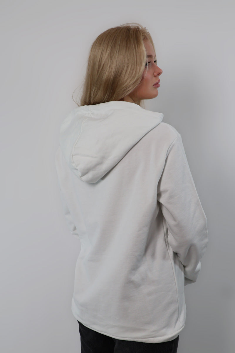 A person with long, flowing hair is photographed facing away, wearing a Nectar Nomad Hoodie. This unisex piece captures the essence of comfort and embodies the spirit of a true Elythee adventurer.